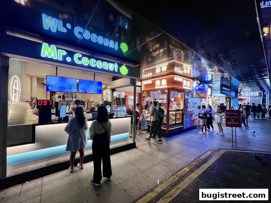 Mr. Coconut shop front with customers ordering at the counter at night.