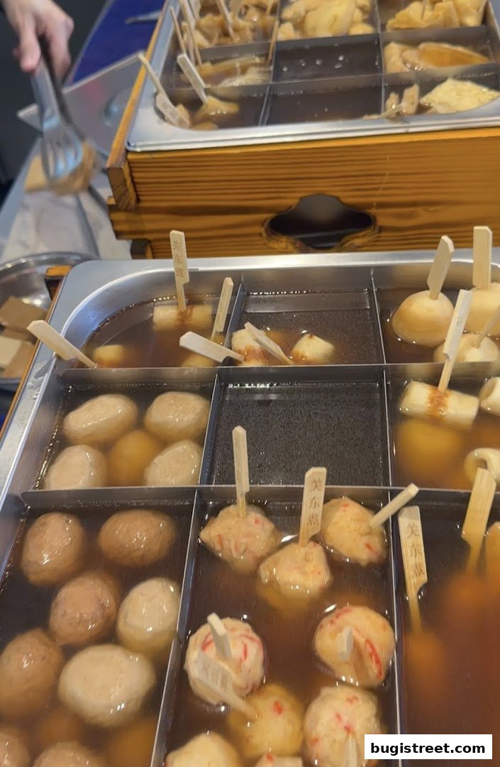A close-up of various oden dishes simmering in a broth, ready to be served.