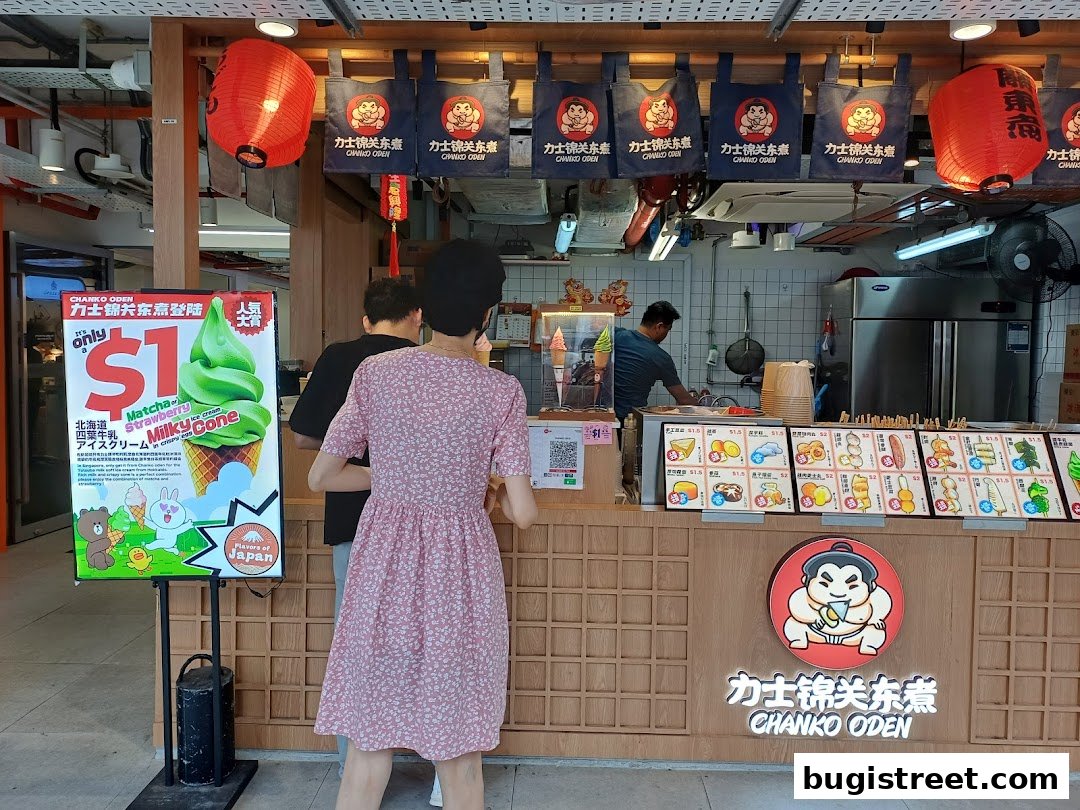 A food stall with a promotional sign for $1 ice cream and a display of various food items.