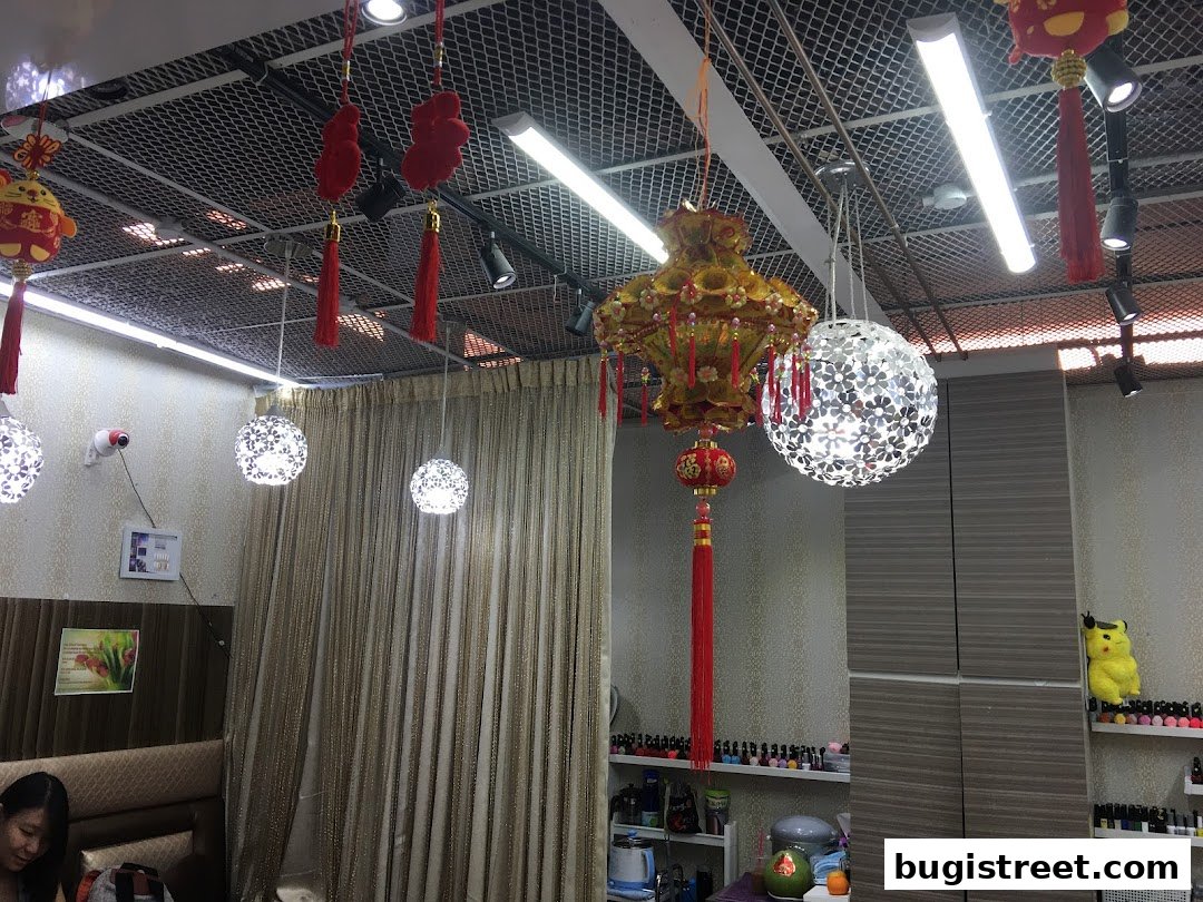 Interior of a nail spa with decorative lanterns, lighting, and shelves of nail polish.