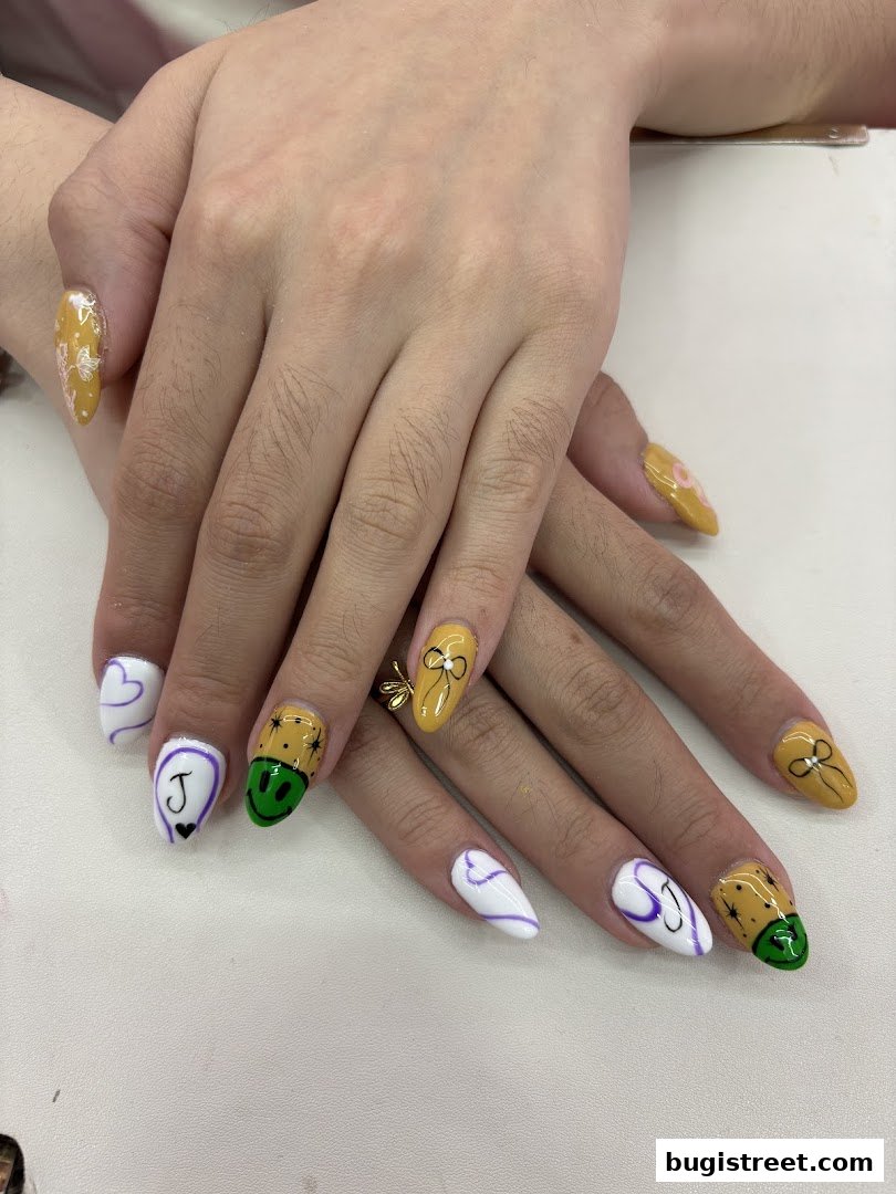 Close-up of hands with creatively designed nails featuring hearts, smiley faces, and bows.