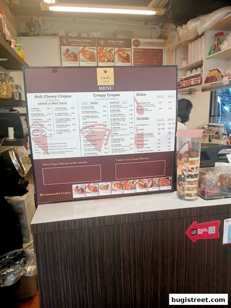 A menu board for Neds Crepes & Coffee, displaying various crepe options and drinks.