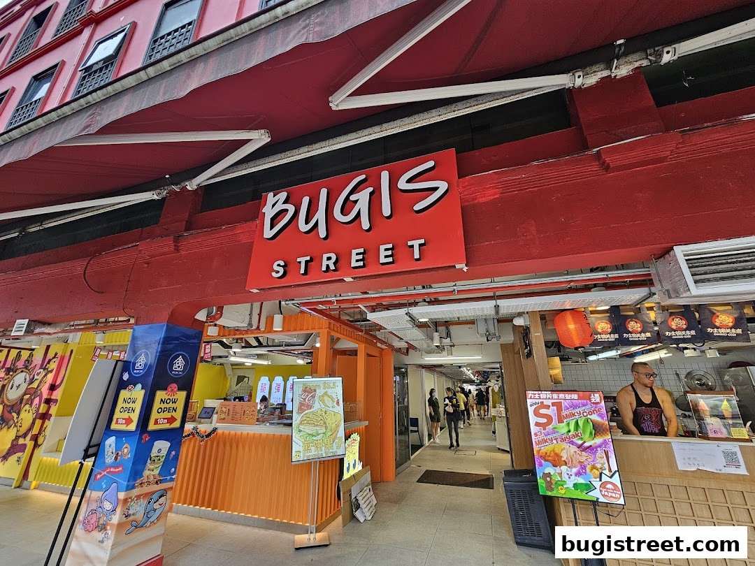 A street view of food stalls at Bugis Street, with a focus on a stall selling Milky Taiyaki and Milky Cones.