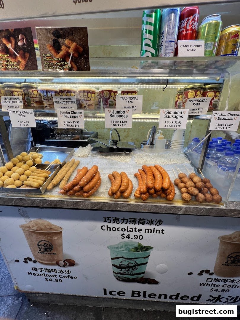 A display case filled with various sausages, cheese sticks, and drinks, with ice blended drinks advertised below.