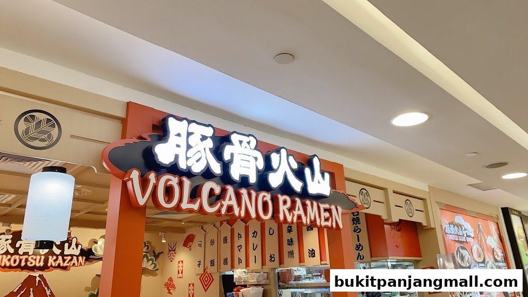 The entrance of Tonkotsu Kazan, a ramen shop, with a prominent illuminated sign.