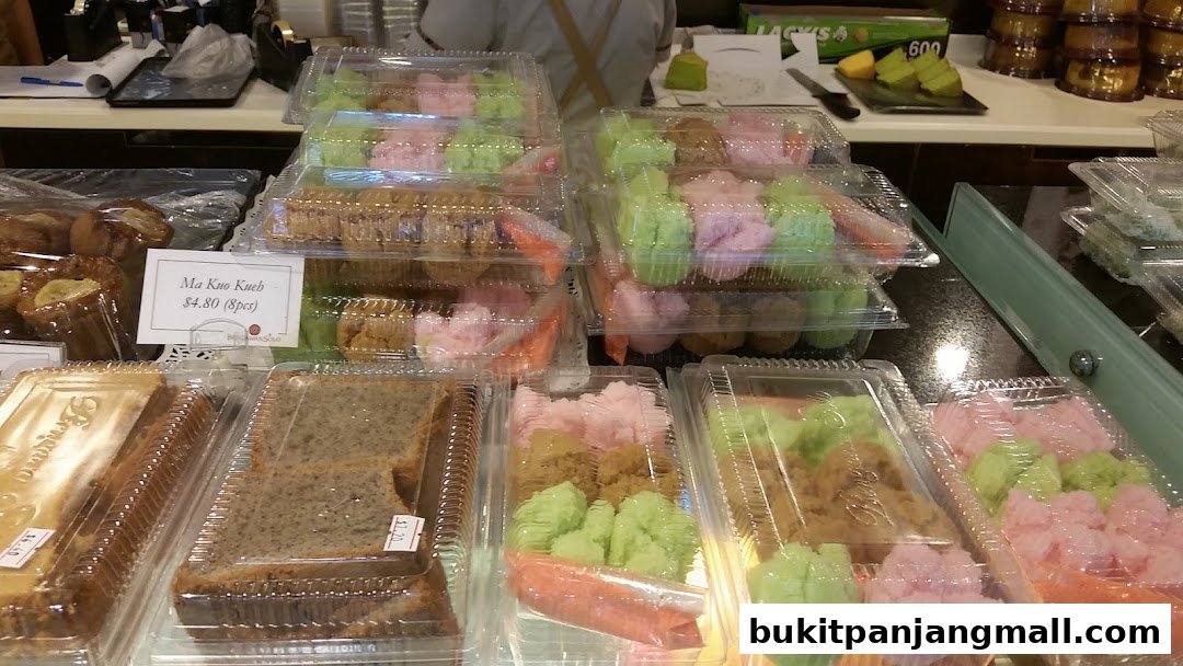 A display of colorful kueh and cakes in clear plastic containers at Bengawan Solo.