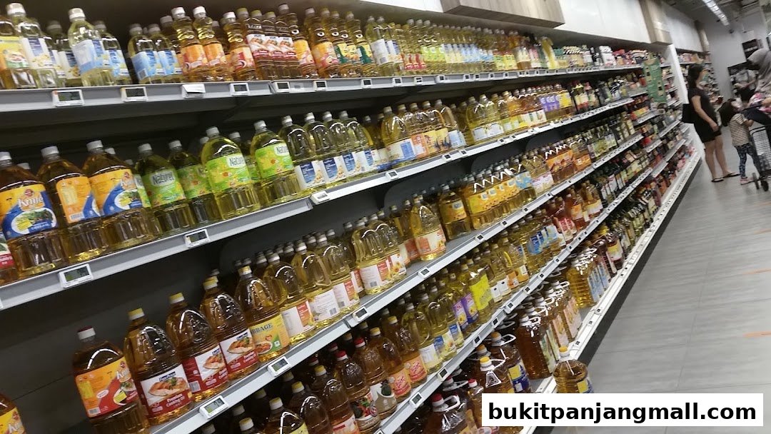 Shelves stocked with various cooking oils in a supermarket aisle.
