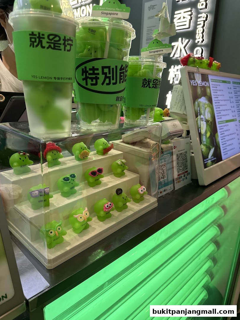 A display of green lemon-themed drinks and cute collectible figures at a shop.