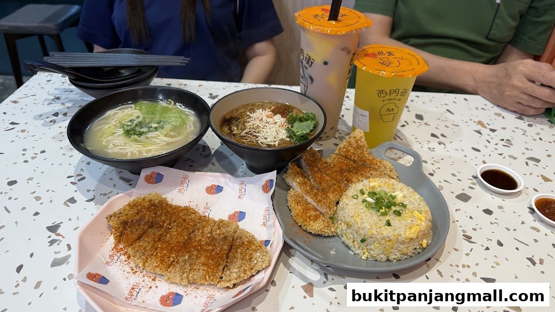 A table laden with Taiwanese dishes including fried chicken, fried rice, noodles, and drinks.