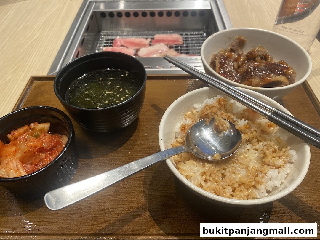 A delicious Yakiniku Like meal featuring grilled meat, rice, kimchi, and soup.