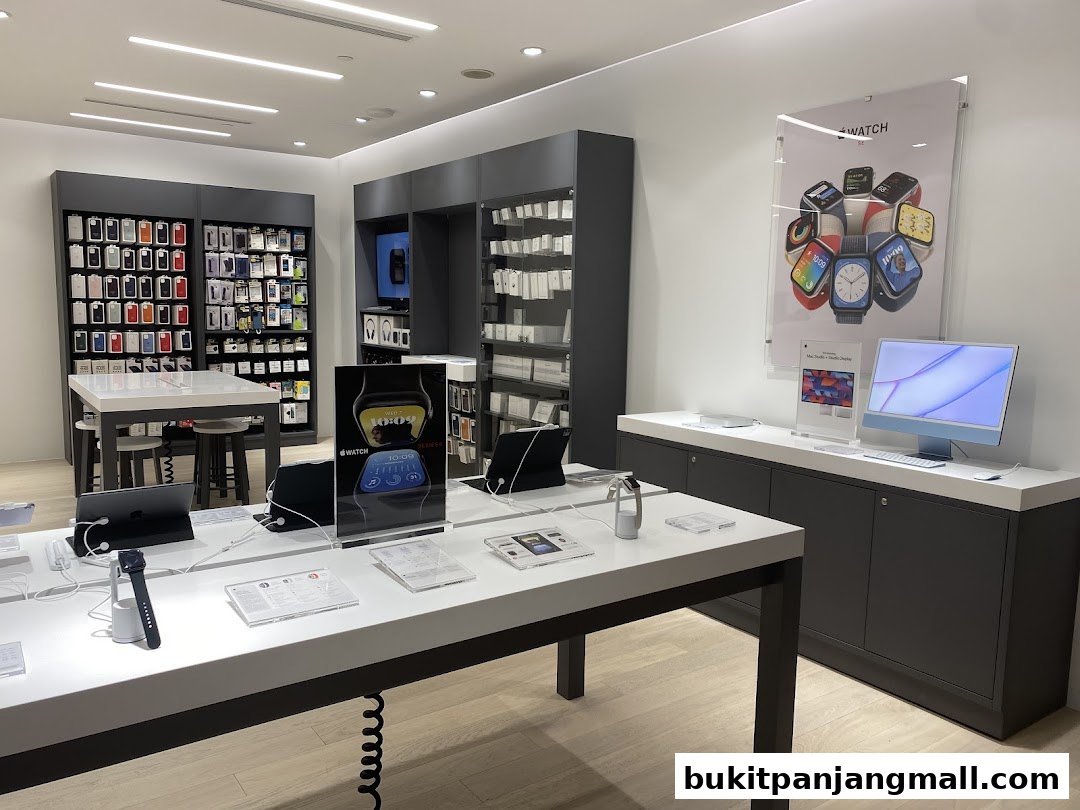 Interior of a modern electronics store showcasing Apple products like watches and computers.