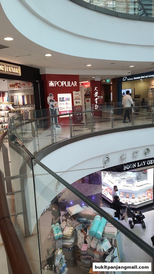 Interior view of a shopping mall with a POPULAR bookstore and other shops visible.