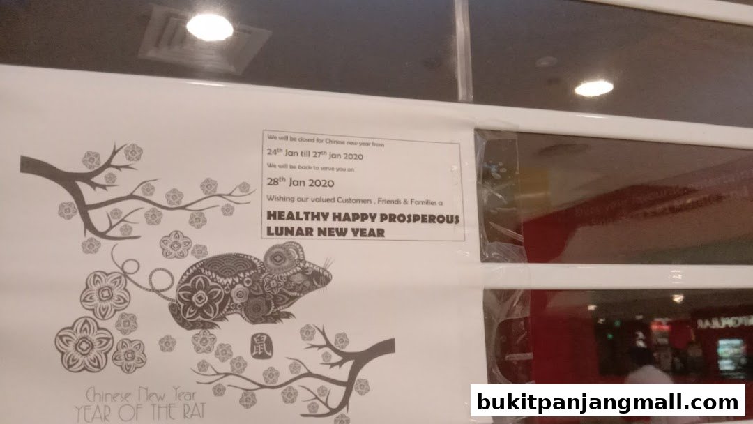 A sign announcing Chinese New Year closure and well wishes, featuring a rat illustration.