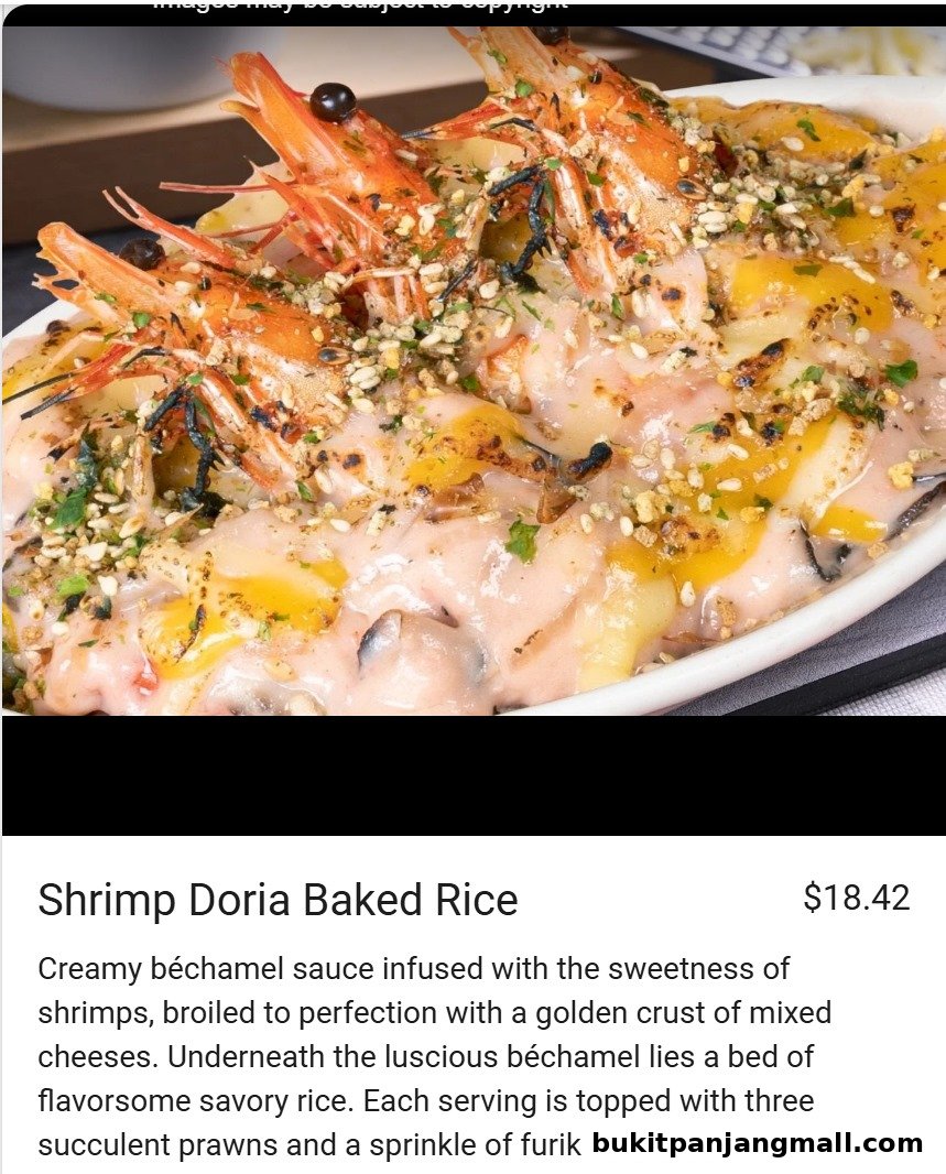 A close-up of a Shrimp Doria Baked Rice dish with creamy sauce and prawns.