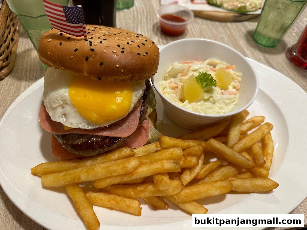 A hearty burger with fries and coleslaw, topped with an American flag.