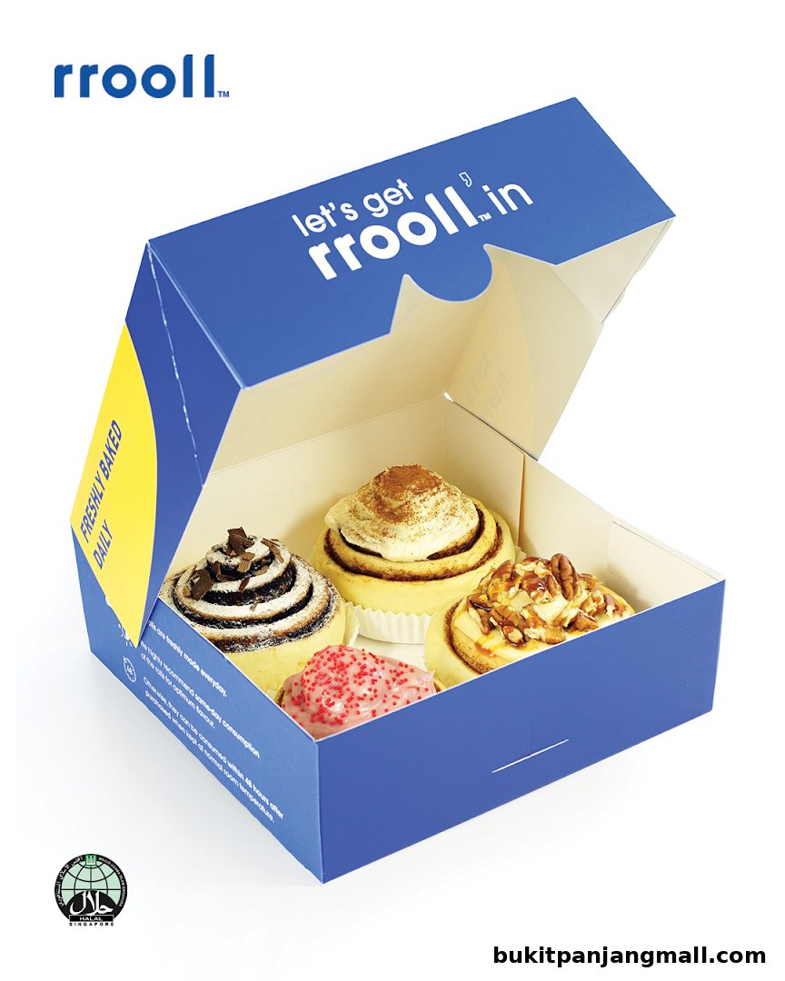 A box of four freshly baked cinnamon rolls with different toppings.