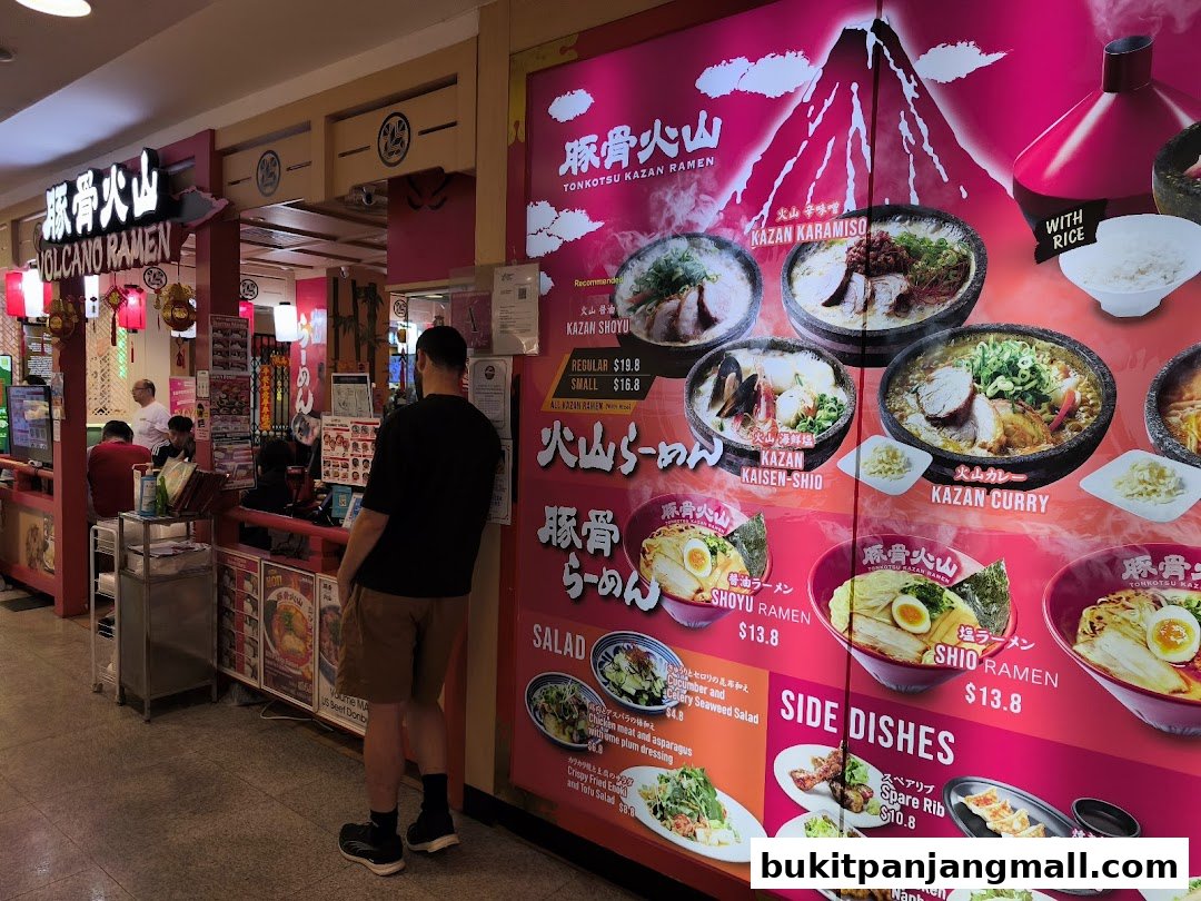 A ramen shop storefront with a large menu display featuring various ramen dishes and side items.