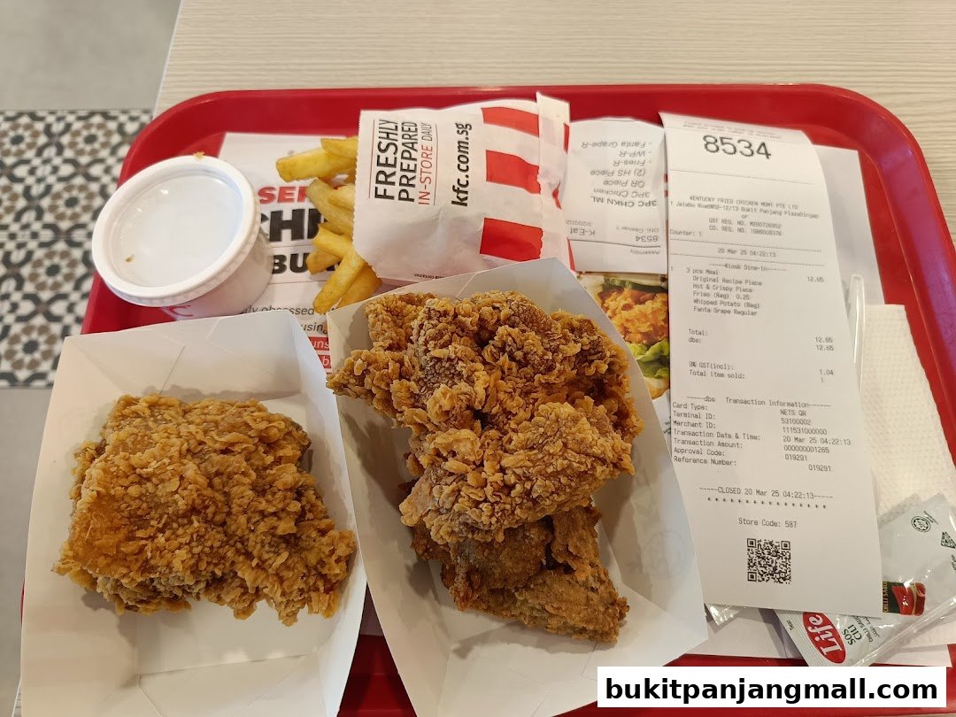 A tray of KFC fried chicken, fries, and a drink, with a receipt.