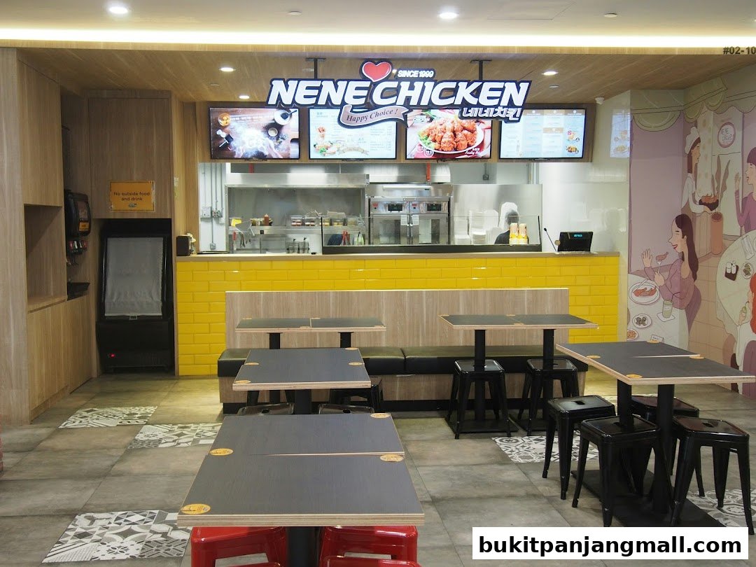 Interior view of NeNe Chicken restaurant with tables, chairs, and a counter.