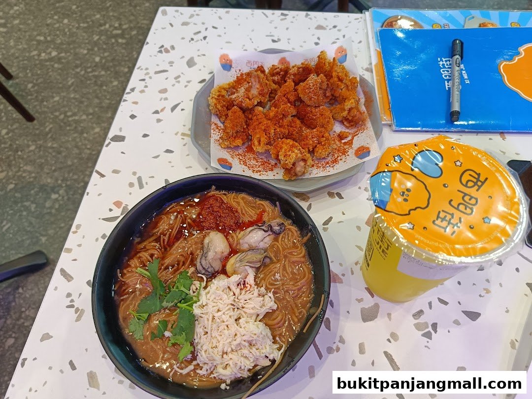 A bowl of Taiwanese oyster mee sua, fried chicken, and a drink are displayed on a table.