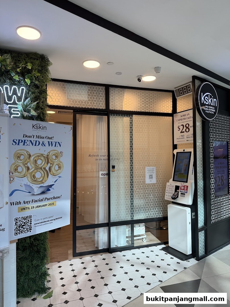 The entrance to Kskin Korean Express Facial, featuring a promotional poster and a self-service kiosk.