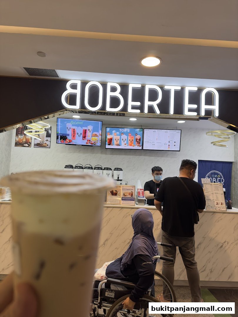 A Bober Tea shop with customers ordering drinks and a person in a wheelchair.