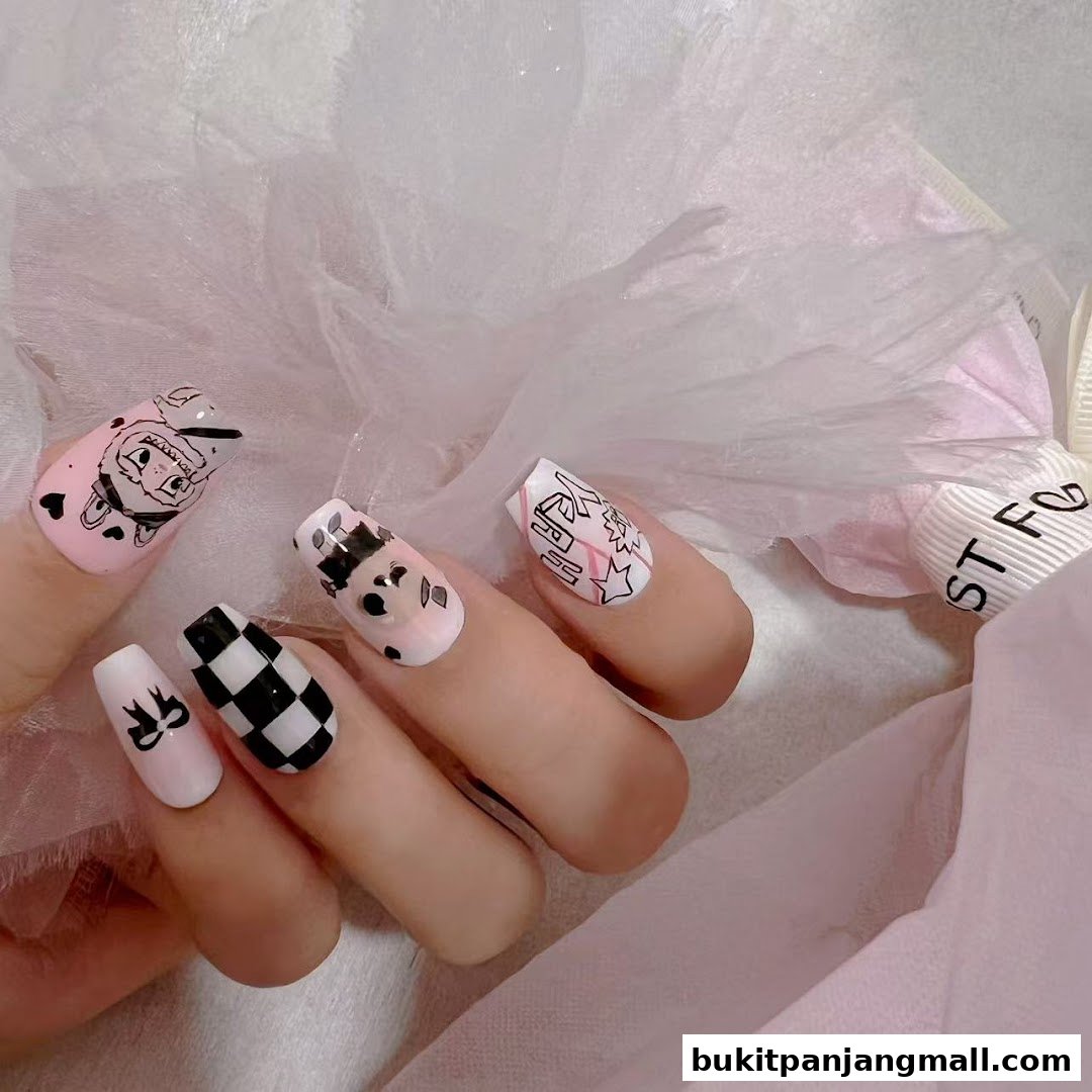 Close-up of a hand with creatively designed nails featuring cartoon characters and patterns.
