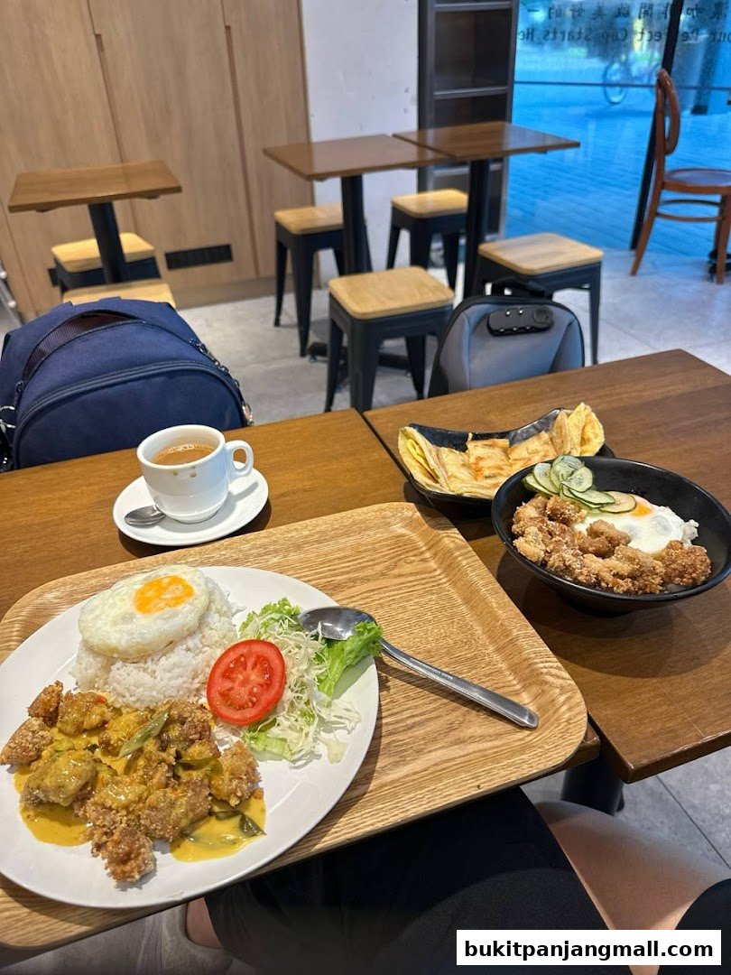 A table at Fong Sheng Hao Bukit Panjang Plaza with two meals and a cup of coffee.