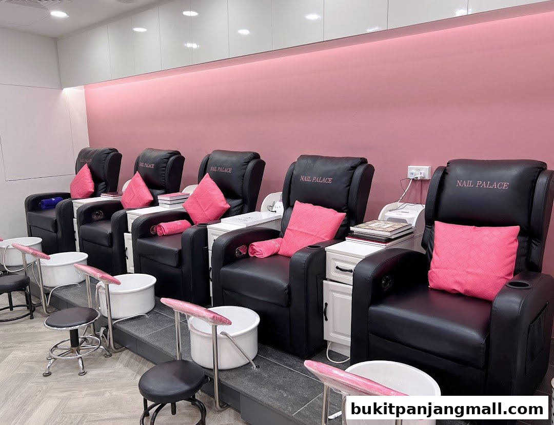 Comfortable pedicure chairs with foot baths and pink cushions at Nail Palace.
