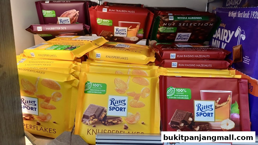 A display of various Ritter Sport chocolate bars, including flavors like Knusperflakes and Rum Raisins Hazelnuts.
