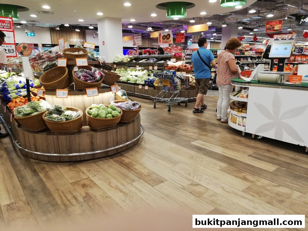 Interior view of a FairPrice Finest supermarket with fresh produce and shoppers at the checkout.