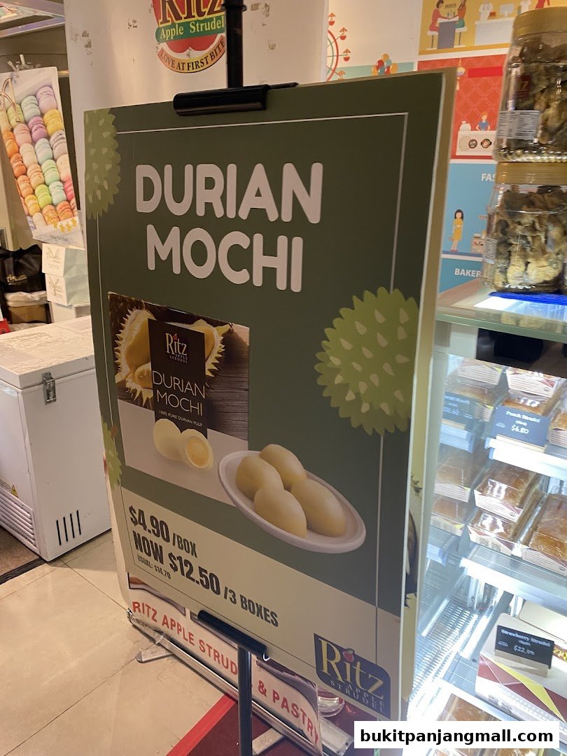 A sign advertising Durian Mochi with pricing and a picture of the product.