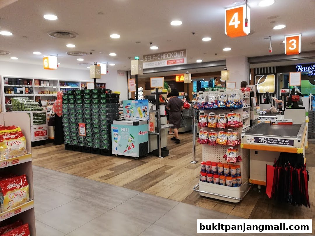 Interior view of a FairPrice Finest supermarket with aisles of products and self-checkout counters.