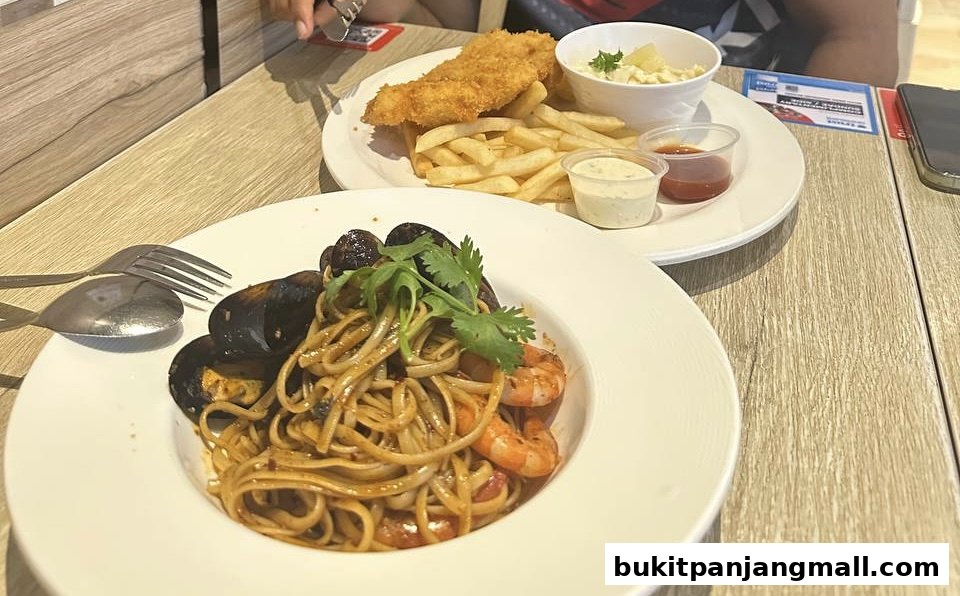 Two plates of food, one with pasta and seafood, the other with fish and chips.