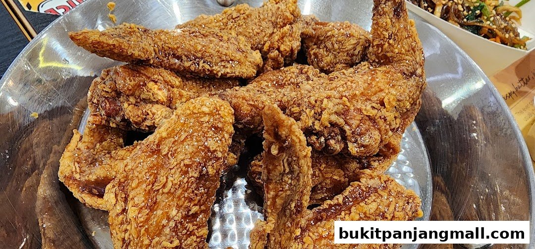 A close-up shot of a platter filled with crispy, golden-brown fried chicken wings.