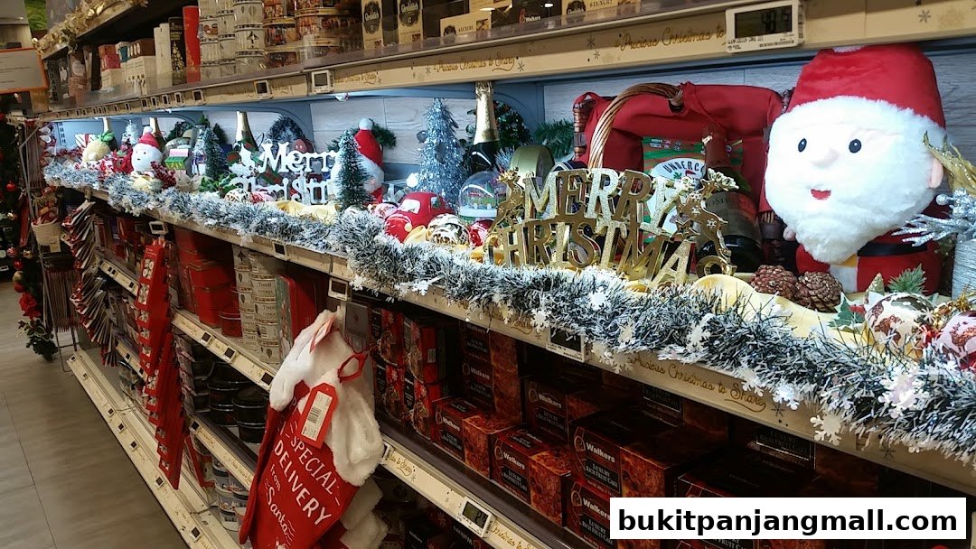 A festive Christmas display featuring Santa, trees, gifts, and holiday decorations on store shelves.