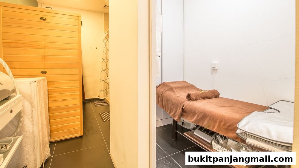 Interior view of a spa room with a massage bed and a wooden sauna.