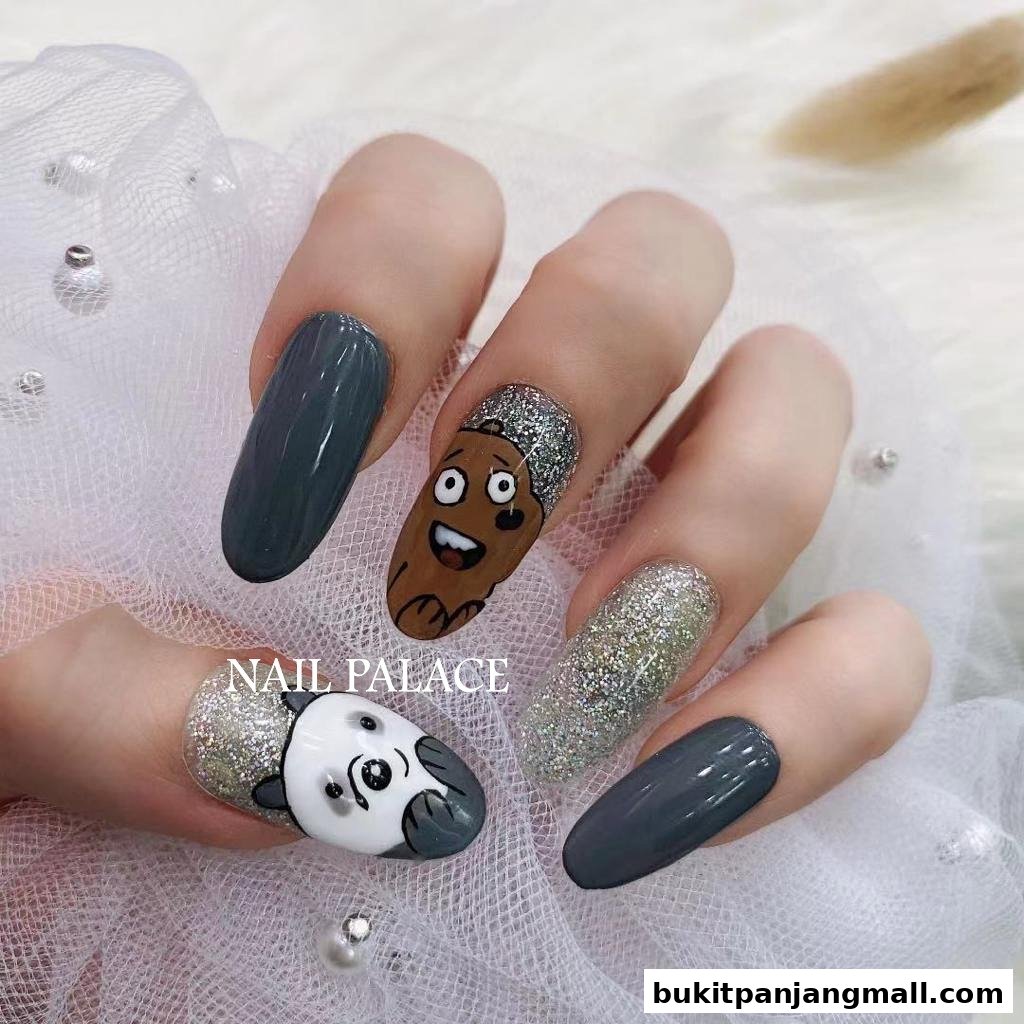 A close-up of hands with creatively designed nails featuring cartoon characters and glitter.