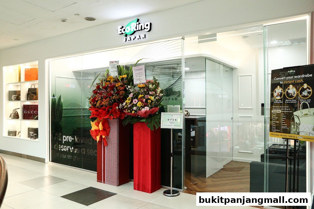 The entrance of EcoRing Japan, a shop selling branded bags and watches, with floral decorations.