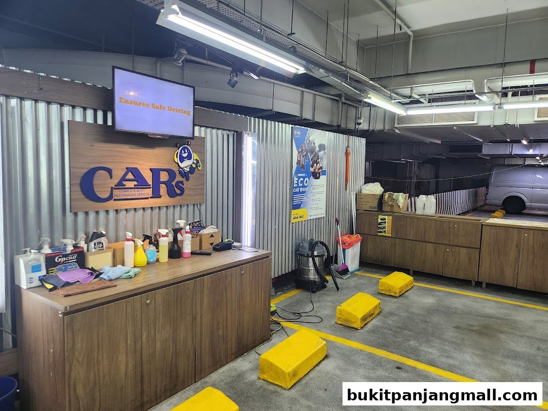 Interior of a car wash and auto restoration service shop with cleaning supplies and equipment.