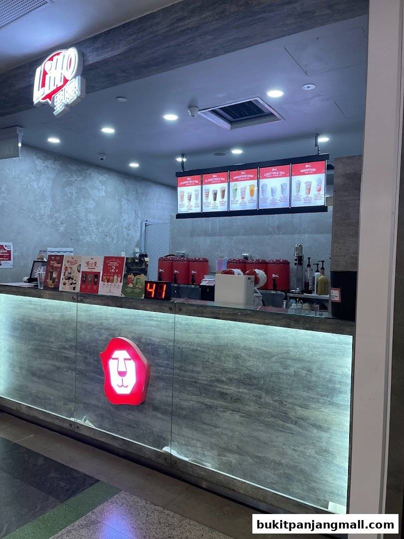 The LiHO TEA shop front with illuminated signage and a digital display.