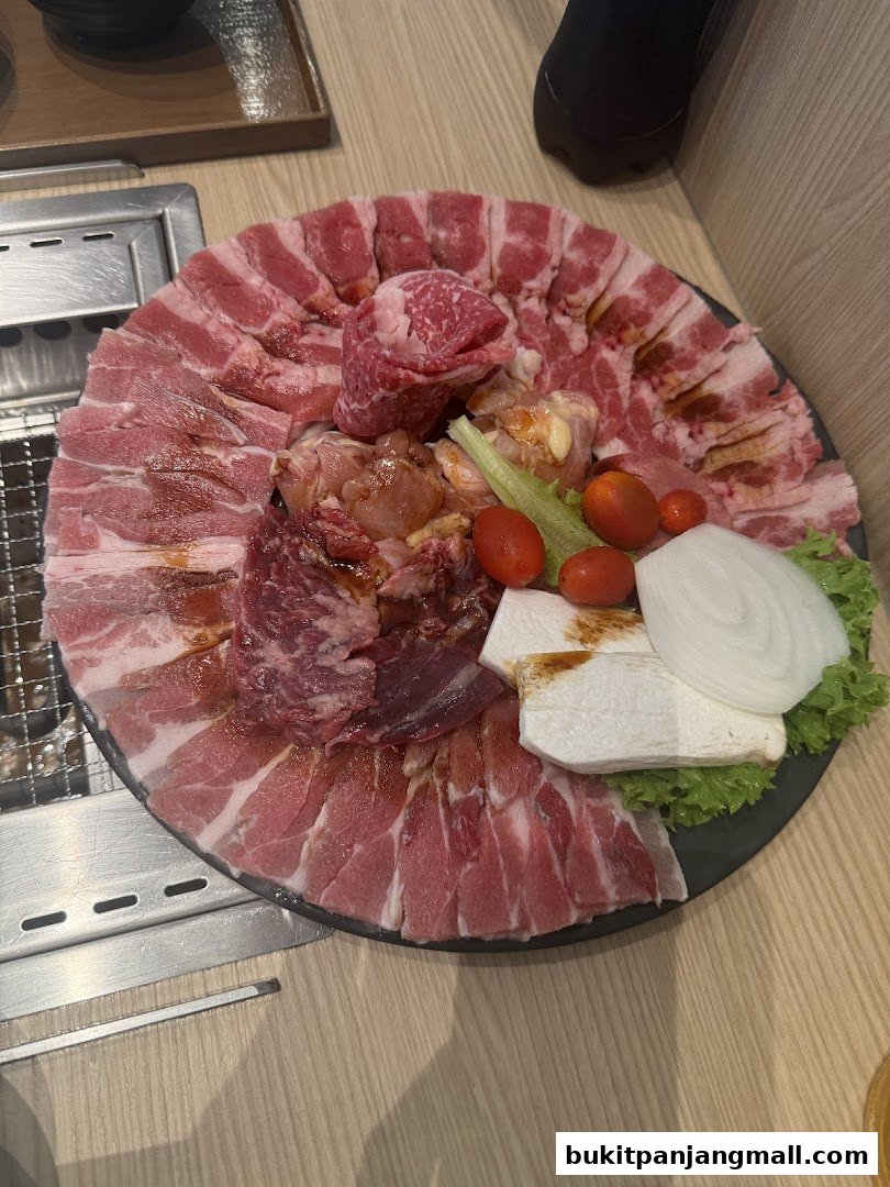 A platter of assorted raw meats and vegetables, ready for grilling at Yakiniku Like.
