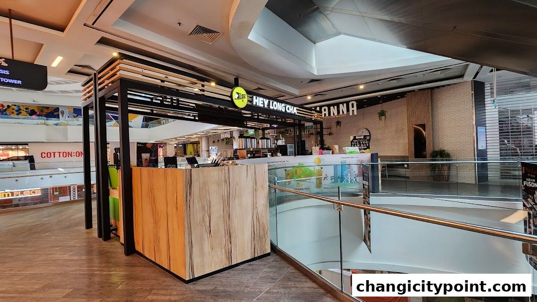 The exterior of a modern bubble tea shop called Hey Long Cha in a shopping mall.
