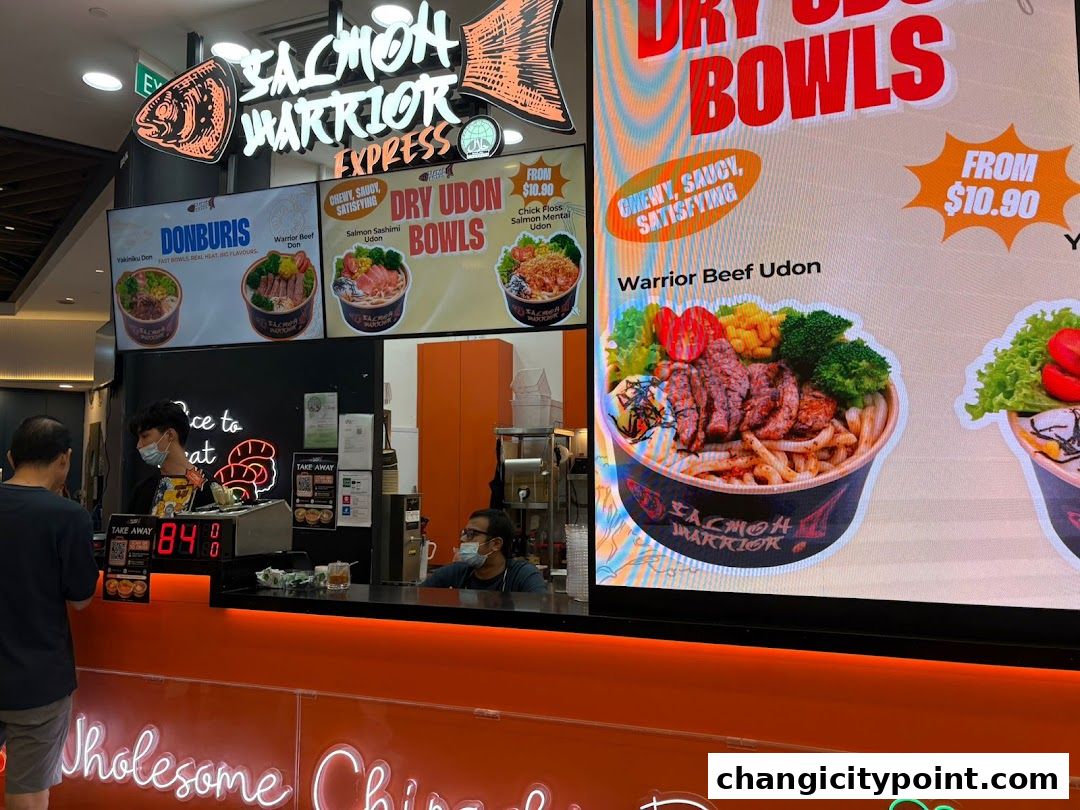 Salmon Warrior Express shop front with digital menu displays showing donburis and udon bowls.