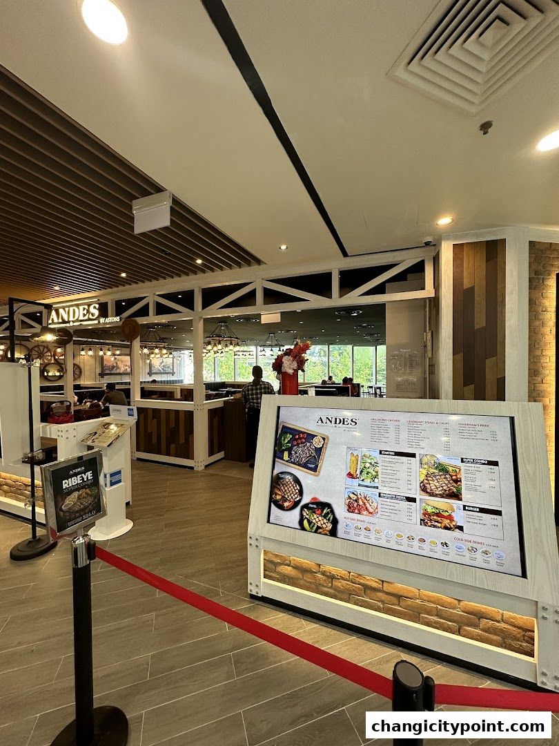 Digital menu board displaying food items and prices at ANDES by ASTONS.