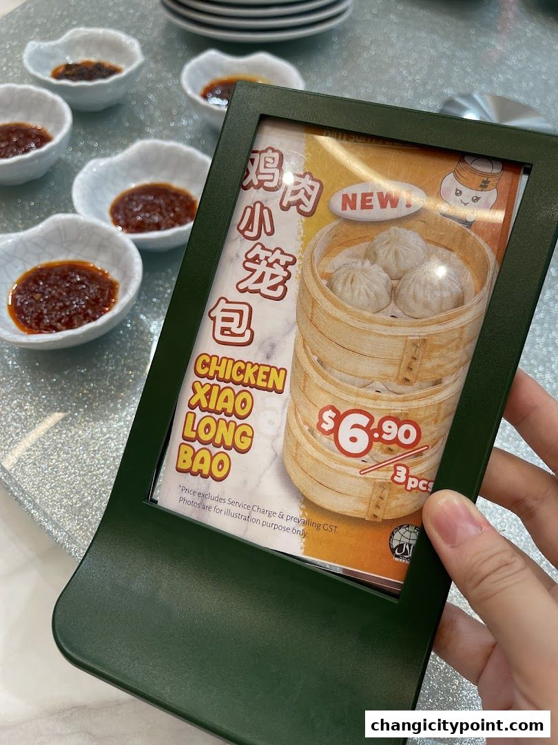 A sign advertising Chicken Xiao Long Bao with a price of $6.90 for 3 pieces.