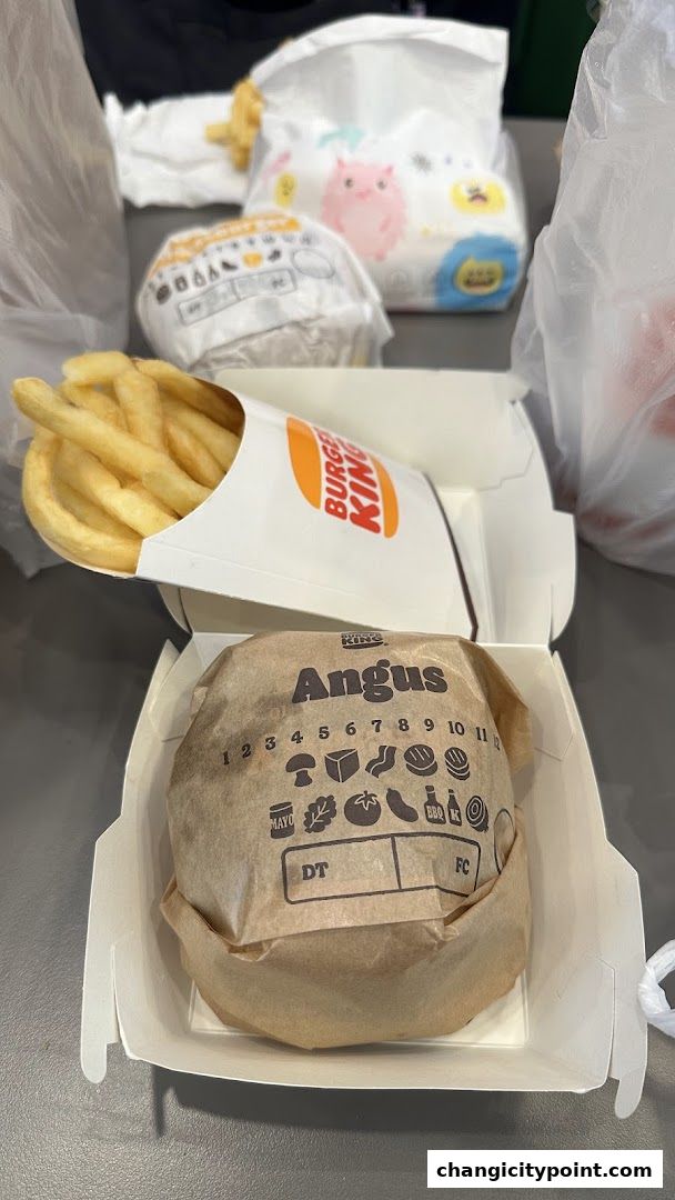Burger King Angus burger and fries in their packaging, ready to eat.