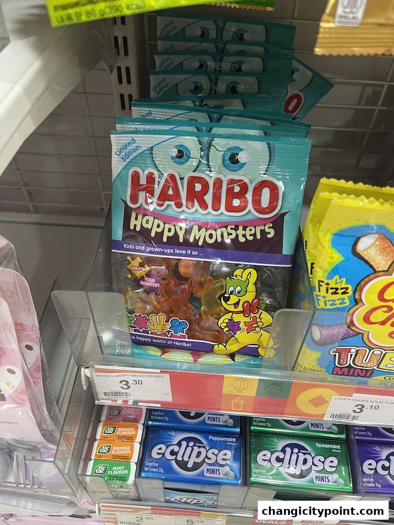 A display of Haribo Happy Monsters candy and various mints at a 7-Eleven store.