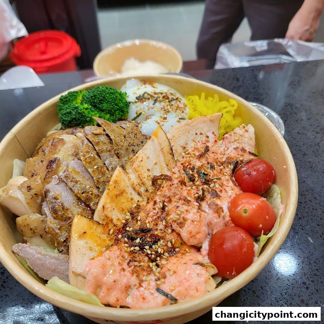 A close-up of a salmon bowl with grilled chicken, broccoli, and cherry tomatoes.