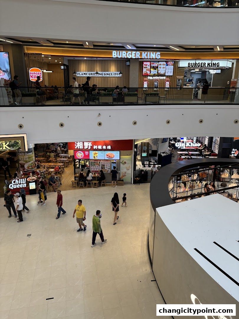 Burger King restaurant with seating area and menu boards visible in a mall.